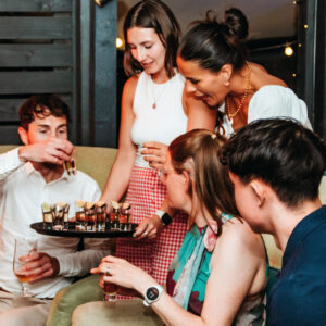 Friends enjoy signature shots at The Square Club's private members' party on the terrace, an inviting space designed for socializing and exclusive private members club events in a cosy and stylish setting.